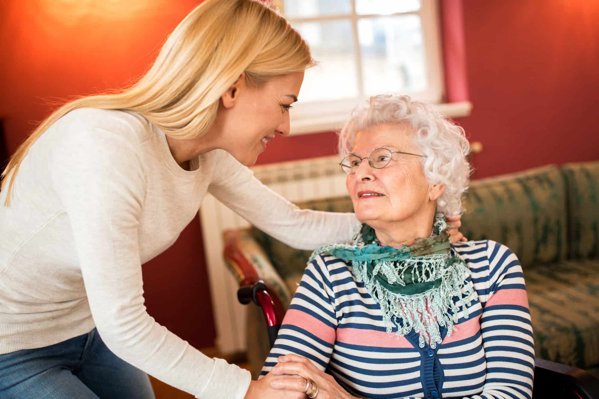 Young woman visit grandmother and support her about health